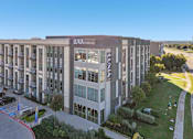 Thumbnail 26 of 26 - A large building with the name "LUXIA PRESIDEN" on it.
