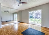 Thumbnail 17 of 62 - an empty living room with a ceiling fan and a window