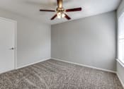 Thumbnail 20 of 62 - an empty room with a ceiling fan and a door