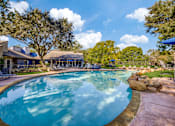 Thumbnail 48 of 62 - a large swimming pool with a house in the background