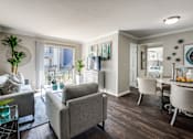 Thumbnail 13 of 62 - a living room and dining room with a table and chairs