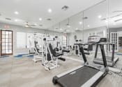 Thumbnail 20 of 20 - a gym with empty chairs and mirrored walls