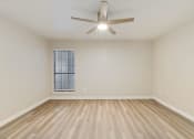 Thumbnail 13 of 28 - a bedroom with hardwood floors and a ceiling fan