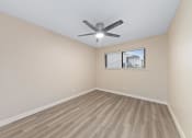 Thumbnail 3 of 17 - a bedroom with hardwood floors and a ceiling fan