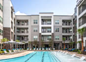 Thumbnail 42 of 43 - front poolside view of the building