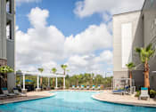 Thumbnail 41 of 43 - pool view with view of palm trees and clouds