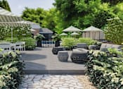 Thumbnail 34 of 37 - A garden with a pathway, white chairs, and umbrellas.