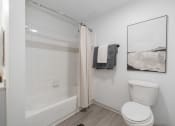 Thumbnail 19 of 35 - a bathroom with a toilet and a tub and a shower