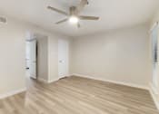 Thumbnail 12 of 28 - a bedroom with hardwood floors and a ceiling fan