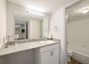 Thumbnail 7 of 34 - a bathroom with a sink and a mirror