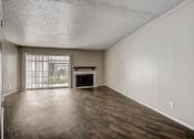 Thumbnail 18 of 36 - a living room with a fireplace and a large window