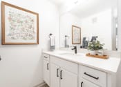 Thumbnail 8 of 26 - a white bathroom with a sink and a mirror