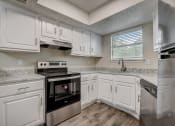 Thumbnail 1 of 26 - a kitchen with white cabinets and stainless steel appliances