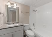 Thumbnail 7 of 17 - a bathroom with a sink toilet and bathtub