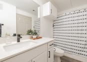 Thumbnail 9 of 26 - a bathroom with a sink and a toilet and a shower