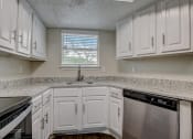 Thumbnail 2 of 26 - a kitchen with white cabinets and granite counter tops