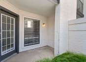Thumbnail 11 of 28 - a patio with a black door and a window with venetian blinds
