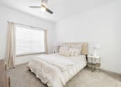 Thumbnail 5 of 26 - a bedroom with a bed and a ceiling fan