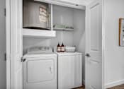 Thumbnail 5 of 33 - laundry room with a washer and dryer and a cabinet above it