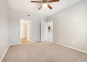 Thumbnail 6 of 37 - a bedroom with a ceiling fan and carpet