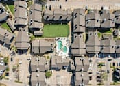 Thumbnail 29 of 40 - A bird's eye view of a residential area with houses and a green lawn.