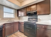 Thumbnail 15 of 36 - a kitchen with dark cabinets and white countertops