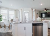 Thumbnail 20 of 43 - a kitchen with white cabinets and a stainless steel dishwasher