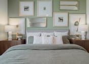 Thumbnail 26 of 43 - a bedroom with green walls and a bed with white and grey bedding