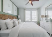 Thumbnail 21 of 43 - a bedroom with a large bed and a ceiling fan