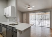 Thumbnail 23 of 29 - a kitchen with a large window and a ceiling fan