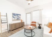 Thumbnail 6 of 20 - a living room with a couch and a table