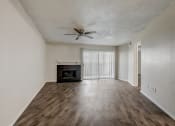 Thumbnail 9 of 36 - a living room with hardwood floors and a fireplace
