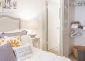 Thumbnail 10 of 34 - a bedroom with a bed with pillows and a closet