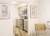 Thumbnail 5 of 34 - a kitchen with stainless steel appliances and a glass table