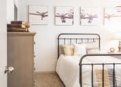 Thumbnail 15 of 34 - a bedroom with a bed and pictures of airplanes on the wall