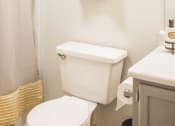 Thumbnail 18 of 34 - a small bathroom with a white toilet and a shower curtain