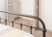Thumbnail 17 of 34 - a closet in a bedroom with a bed and a fan