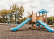Thumbnail 33 of 34 - a playground with a slide at a park