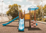 Thumbnail 32 of 34 - a playground with a swing set and a slide
