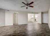 Thumbnail 7 of 26 - an empty living room with a ceiling fan
