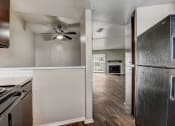 Thumbnail 17 of 36 - a kitchen and living room with a ceiling fan