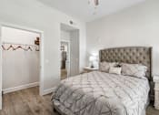 Thumbnail 9 of 42 - A bedroom with a large bed and a dresser.