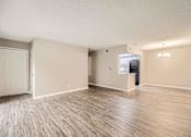 Thumbnail 8 of 22 - A spacious room with wood flooring and a television.