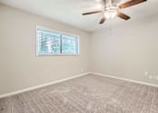 Thumbnail 16 of 22 - A room with a ceiling fan and a window with blinds.