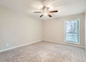 Thumbnail 13 of 22 - A room with a ceiling fan and a window with blinds.