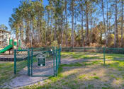 Thumbnail 28 of 30 - A playground with a green slide and a sign that says
