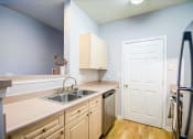 Thumbnail 22 of 29 - a kitchen with a sink and a refrigerator