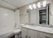 Thumbnail 12 of 36 - a bathroom with a sink toilet and bathtub