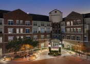 Thumbnail 21 of 22 - a large building with a fountain at night