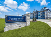 Thumbnail 37 of 37 - an apartment building with a sign for farmhouse modern living on top of a hill